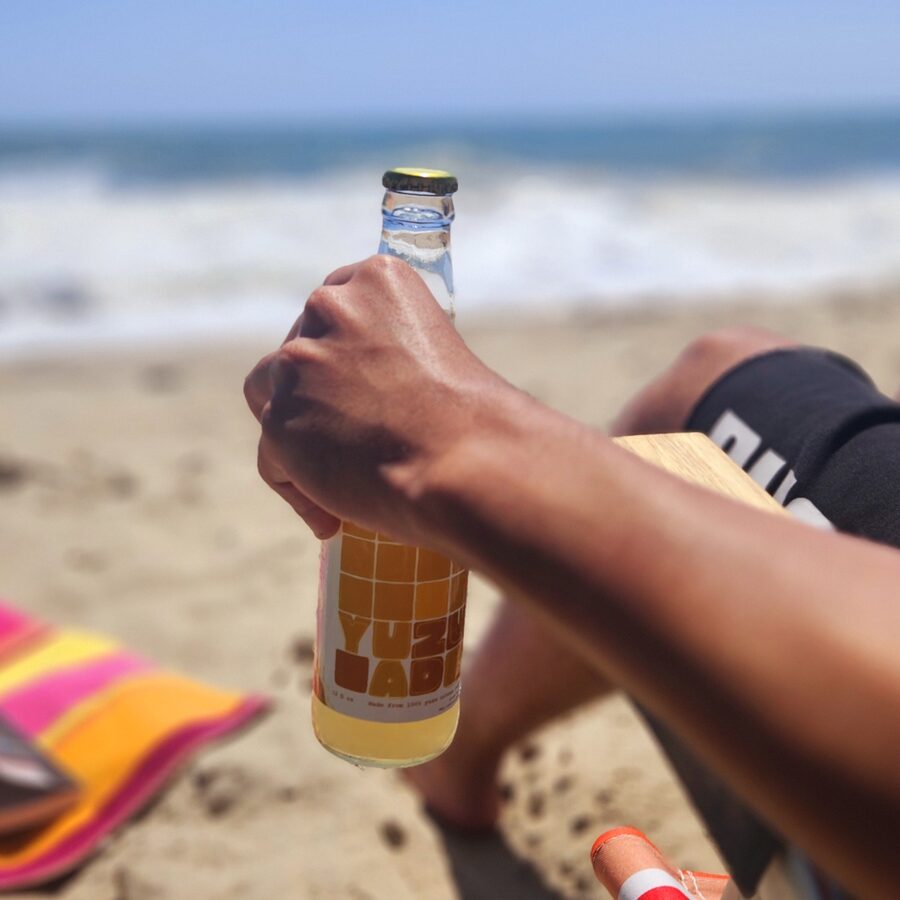 YUUZ bottle held at the beach